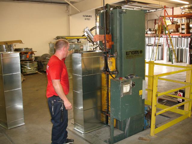 Fabricator working a sheet metal machine